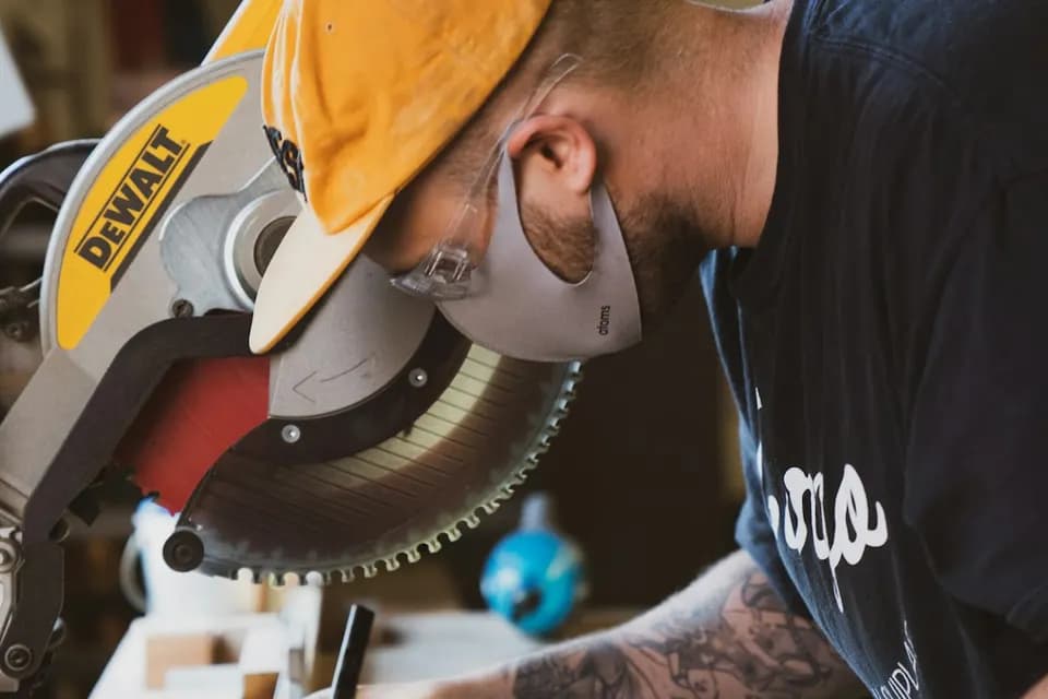 Skilled carpenter cutting wood - carpentry services in Dubai by Top Fixers