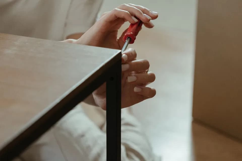 Flat-pack furniture being assembled with hand tools in a Dubai apartment